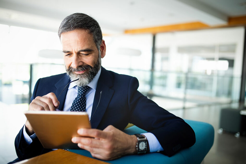 business guy reading his tablet