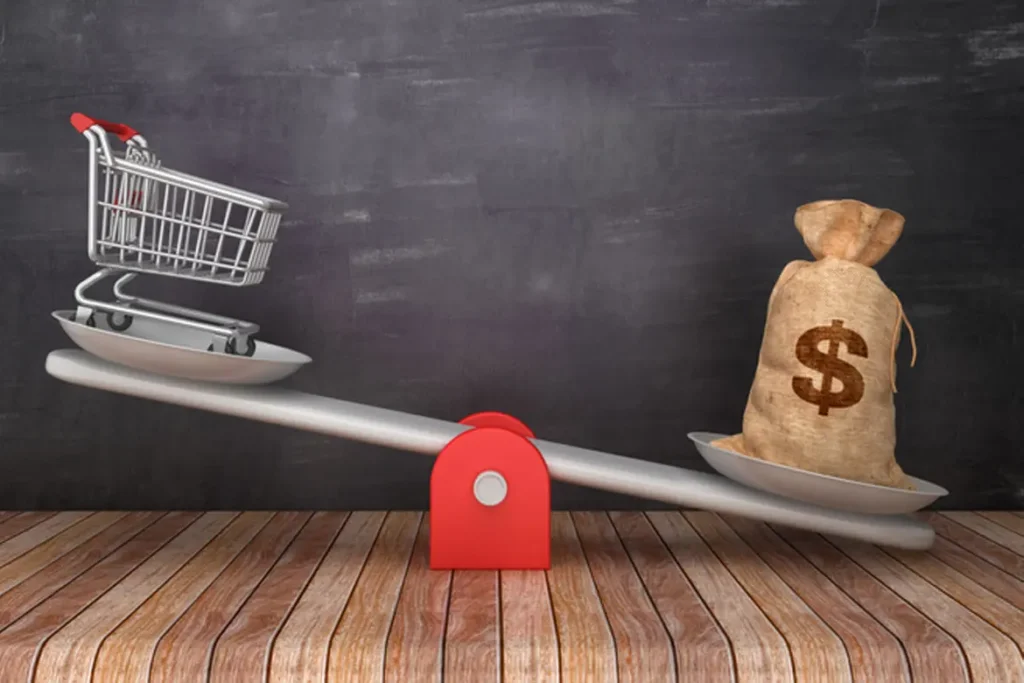 shopping cart on seesaw with a bag of money