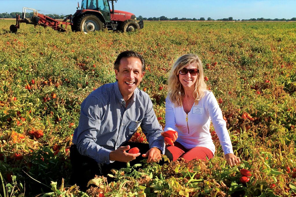 Owners George and Stacy in California sourcing the selected Roma tomatoes that go in their marinara sauce—amazingly, never more than six hours passes from freshly picking their tomatoes to canning.