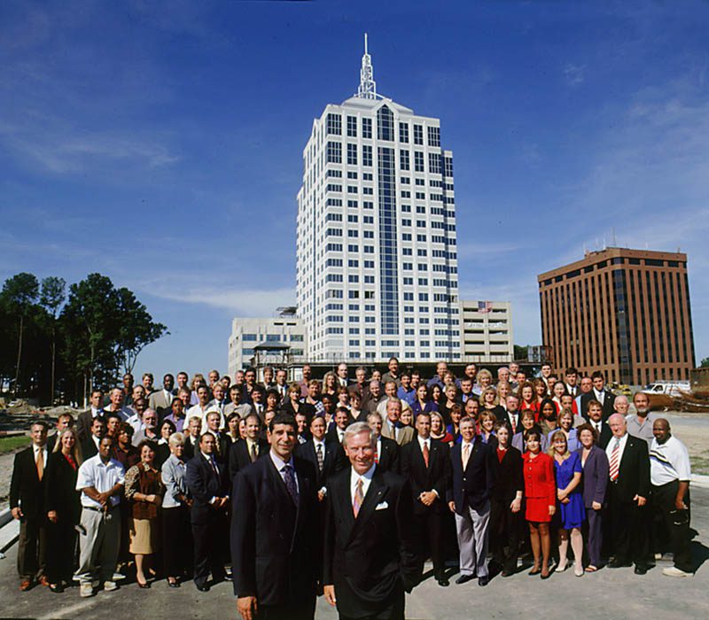 The Armada Hoffler team in from of the Armada Hoffler tower in 2002 when it first opened its doors in Town Center of Virginia Beach.